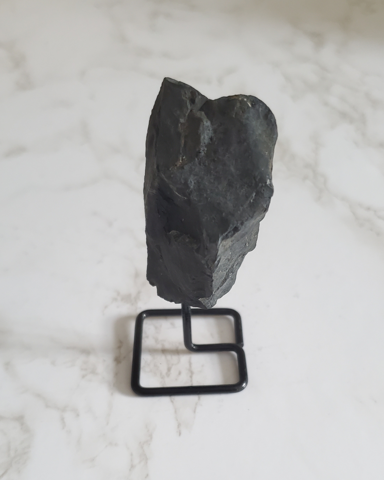 Natural Pain Relief and Protection from 5G and EMFs a Raw Piece of Shungite on a Stand